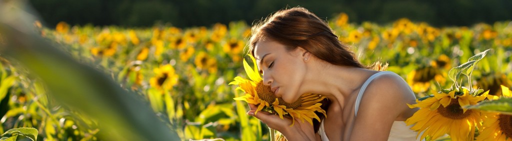 I,agen en color de una muchacha con un girasol en la mano en un campo de girasoles